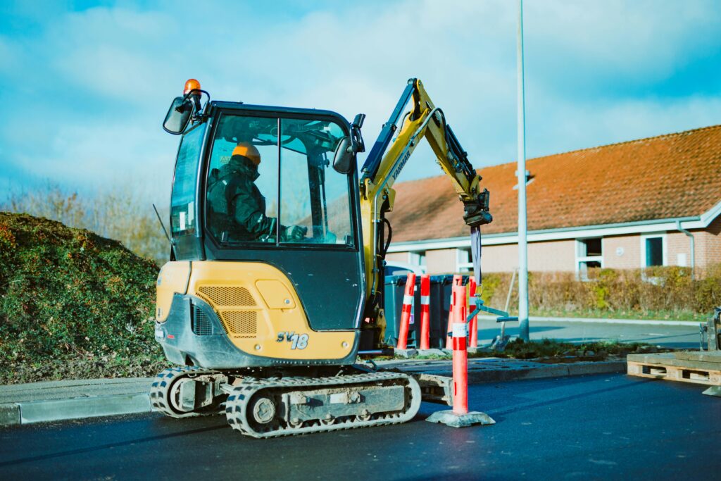 Mini excavator in action: A man operating the machine