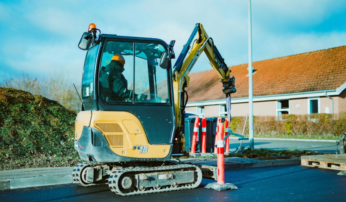 Mini excavator in action: A man operating the machine